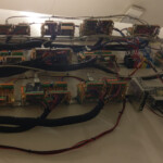 SimStacks mounted on the side of a 747-400 fuselage, controlling the overhead panels.